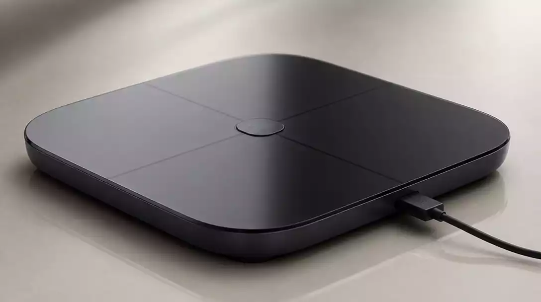 Hume Scale connected to a charging cable, illustrating the charging port