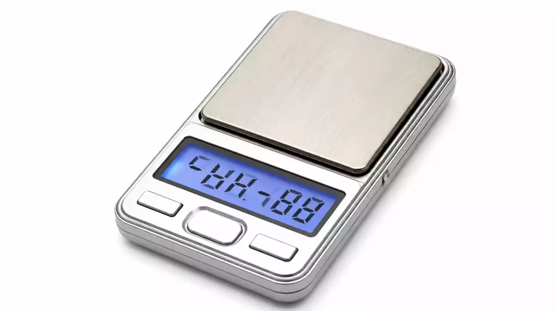 Close-up of a digital pocket scale displaying an error message or jumbled numbers, indicating malfunction