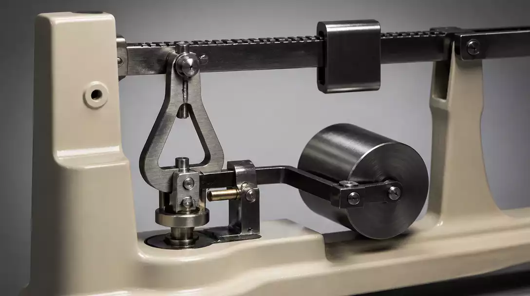 Detailed view of a mechanical beam scale's trig loop and counterpoise