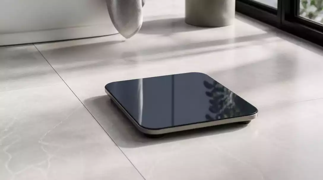 Modern digital bathroom scale on a clean bathroom floor